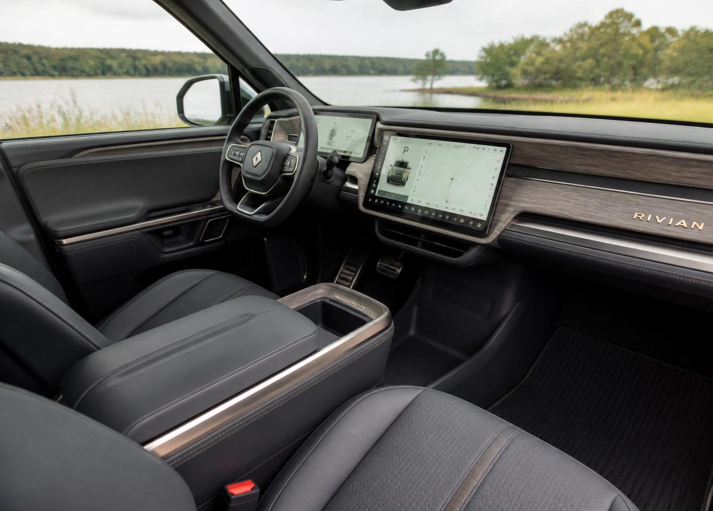Realistic Rivian electric vehicle interior showing dashboard, vegan leather seats, and wood trim